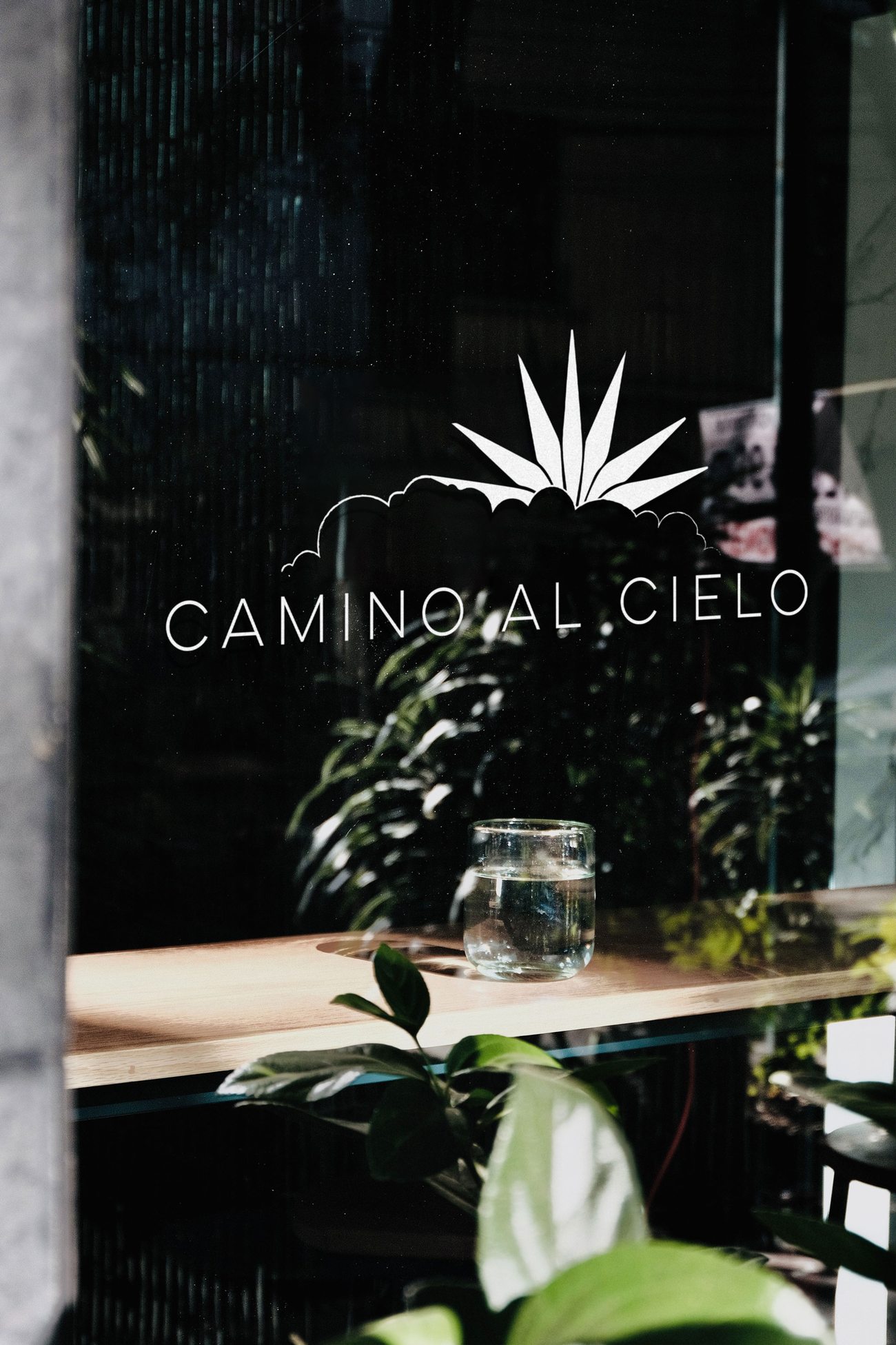Camino al Cielo storefront window signage