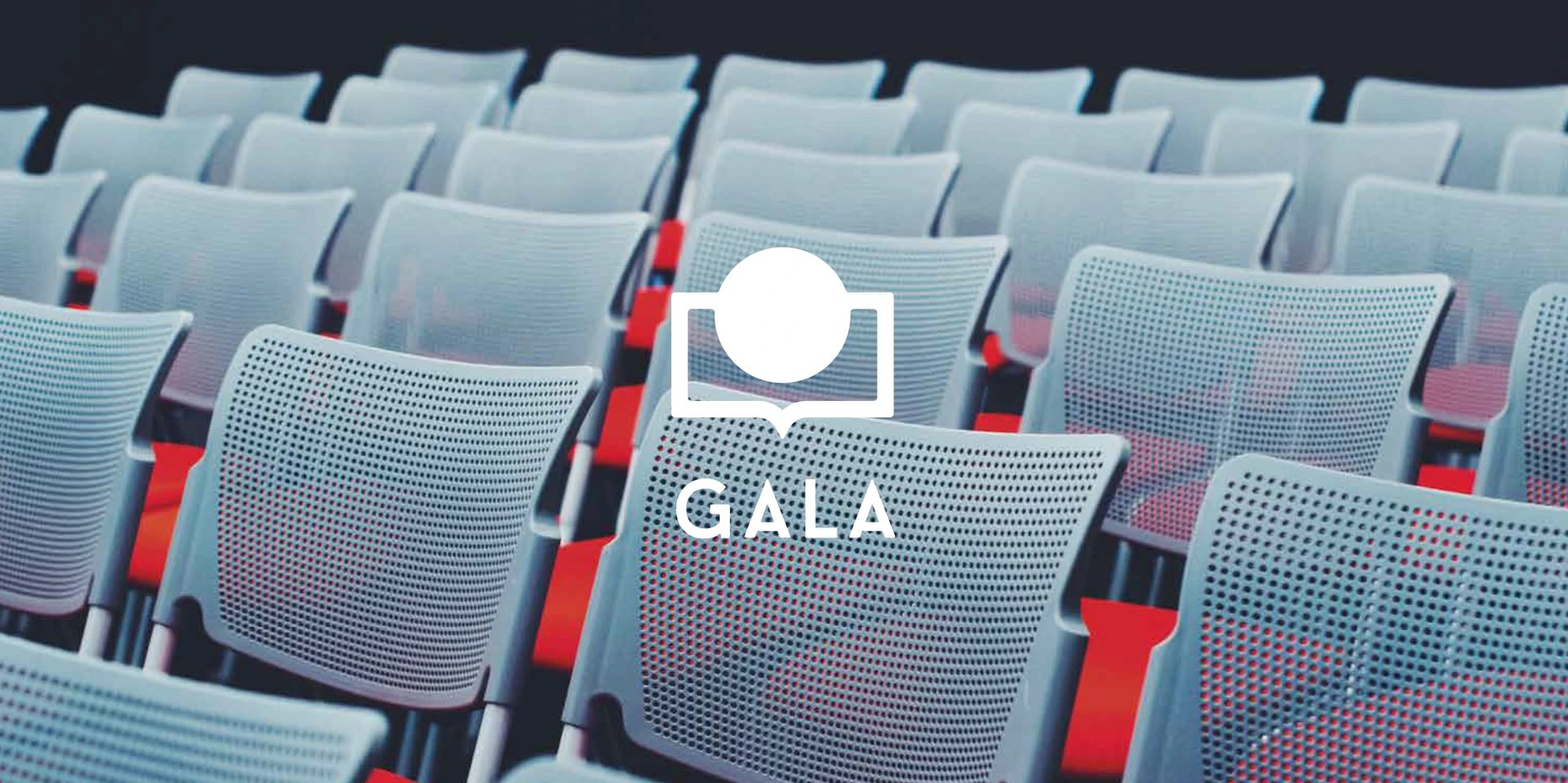 GALA Instituto mark over rows of auditorium seating