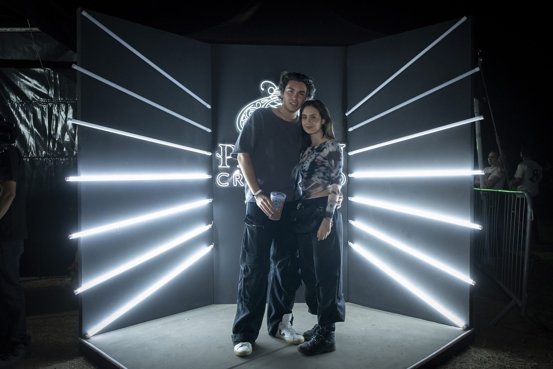 Guests posing in the neon light ray photo booth
