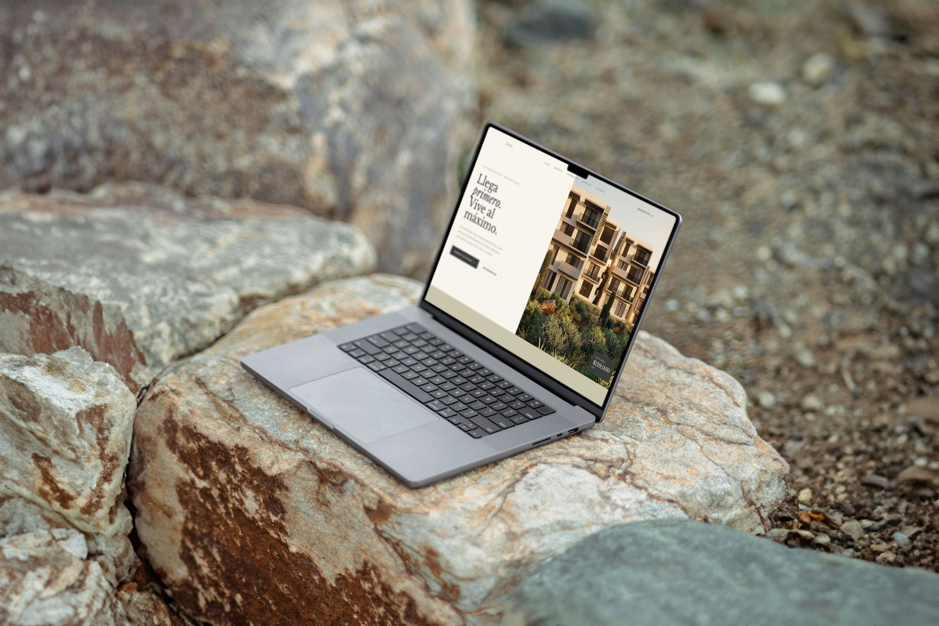 Sabina website shown on a laptop resting on the rocks of Los Cabos